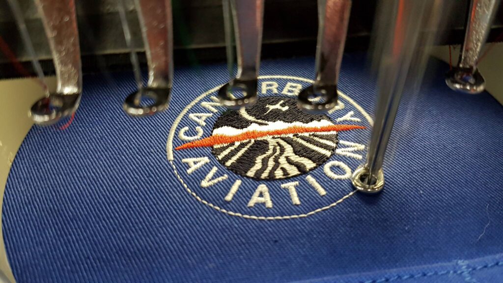 embroidery machine working on custom logo